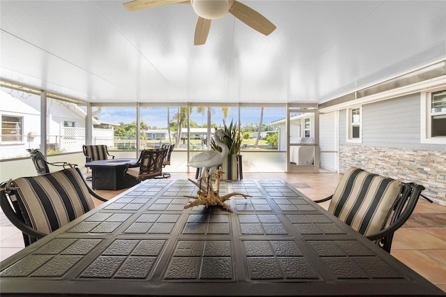 sunroom / solarium featuring a ceiling fan