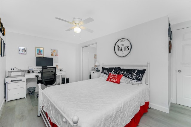 bedroom featuring a closet, baseboards, a ceiling fan, and light wood finished floors