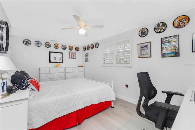 bedroom featuring baseboards, a ceiling fan, and wood finished floors