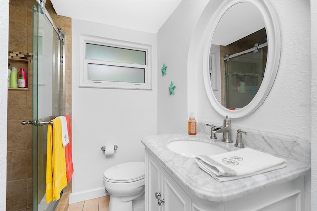 bathroom featuring vanity, toilet, baseboards, and a stall shower