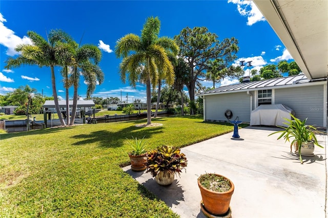 view of yard featuring a boat dock and a patio