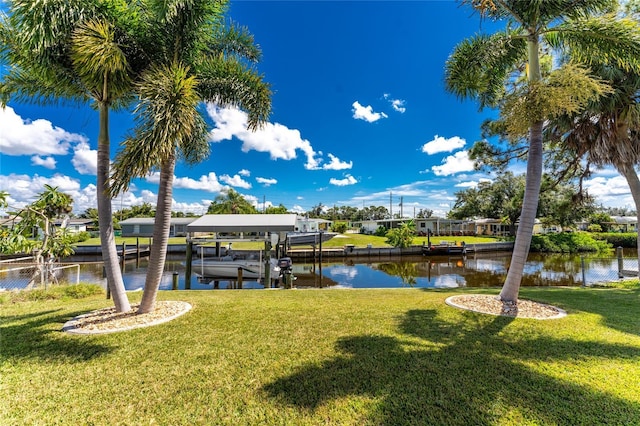 view of dock featuring a yard and a water view