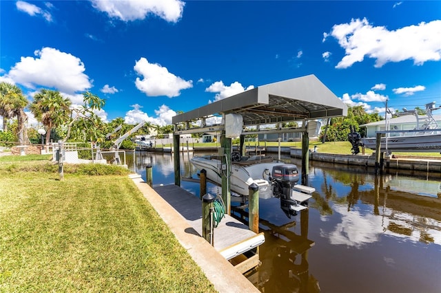 view of dock with a yard, a water view, and boat lift