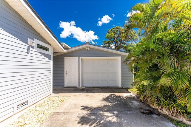 garage featuring concrete driveway