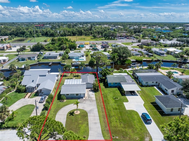 birds eye view of property with a residential view and a water view