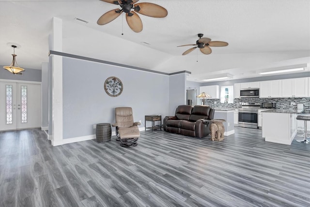 living room featuring french doors, vaulted ceiling, ceiling fan, and hardwood / wood-style floors