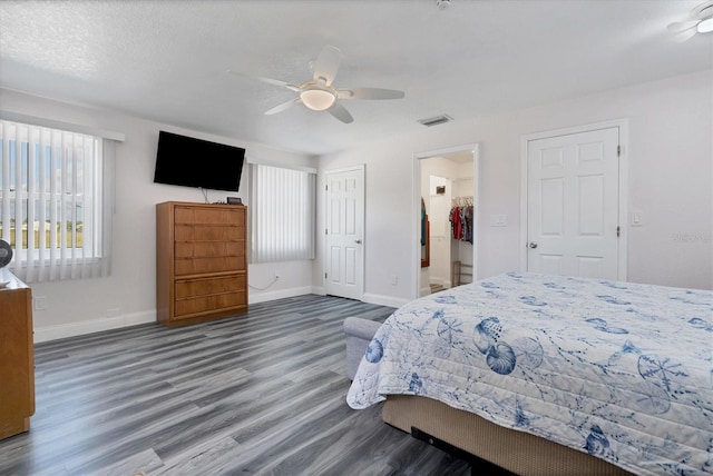 bedroom featuring ceiling fan and dark wood-type flooring