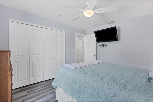 bedroom with wood-type flooring and ceiling fan