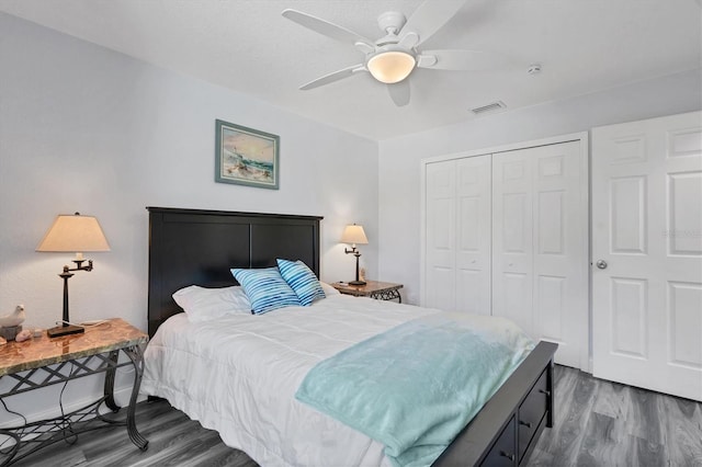 bedroom with wood-type flooring, a closet, and ceiling fan