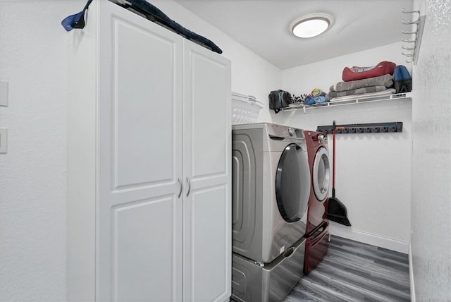 washroom featuring dark hardwood / wood-style flooring and washing machine and dryer