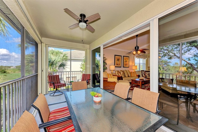 sunroom / solarium featuring ceiling fan