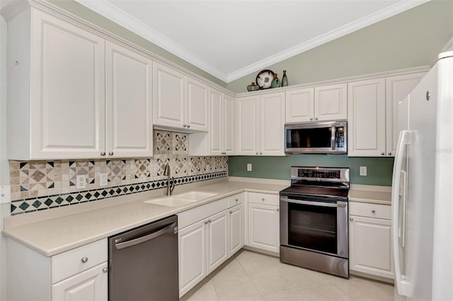 kitchen featuring sink, white cabinetry, crown molding, stainless steel appliances, and backsplash