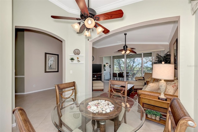 tiled dining room featuring vaulted ceiling, ornamental molding, and ceiling fan