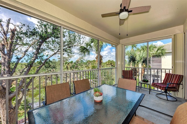 sunroom featuring ceiling fan