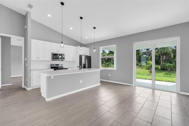 kitchen featuring a center island with sink, white cabinetry, pendant lighting, and stainless steel appliances