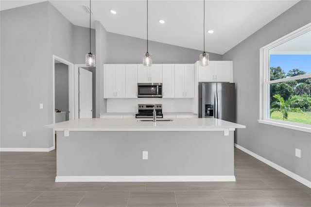 kitchen featuring white cabinets, an island with sink, appliances with stainless steel finishes, and sink