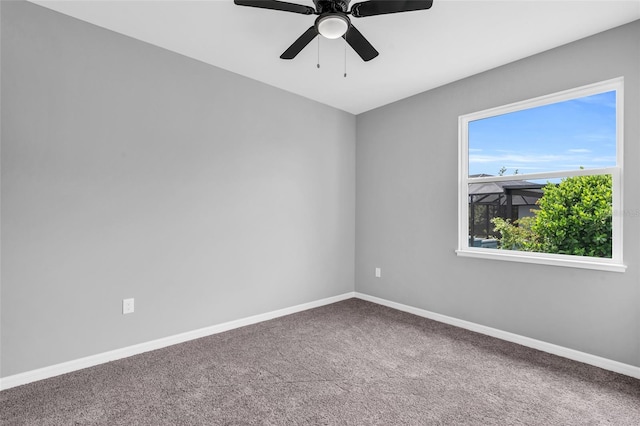 carpeted spare room with ceiling fan