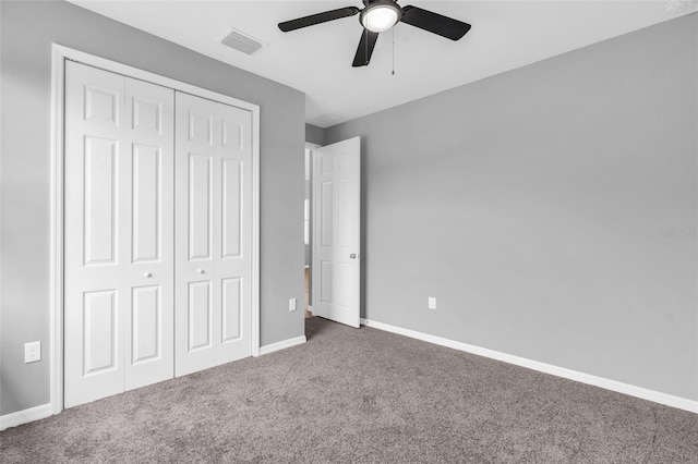 unfurnished bedroom with carpet floors, ceiling fan, and a closet