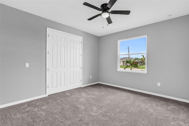 unfurnished bedroom featuring a closet, ceiling fan, and carpet floors