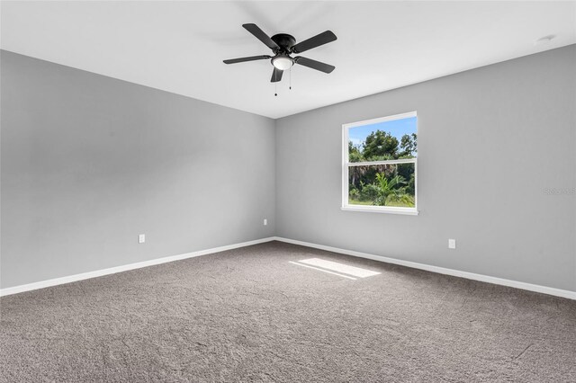 empty room with carpet flooring and ceiling fan