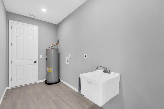 laundry room featuring hookup for a washing machine, electric water heater, sink, and hookup for an electric dryer