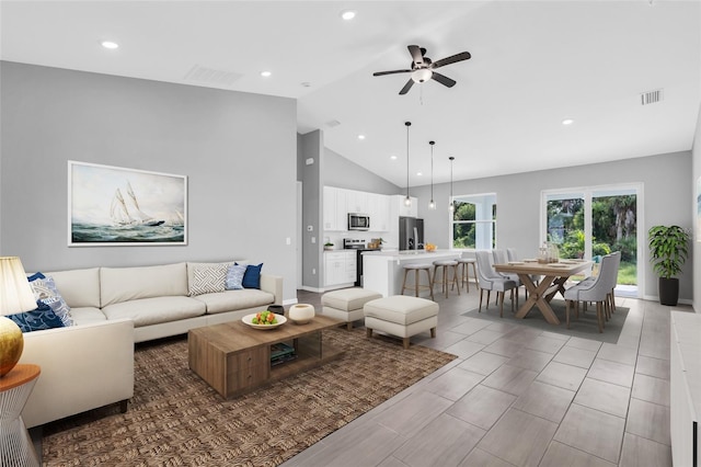 living room featuring high vaulted ceiling and ceiling fan