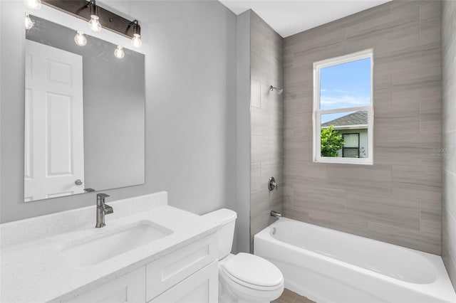 full bathroom with tiled shower / bath combo, vanity, and toilet