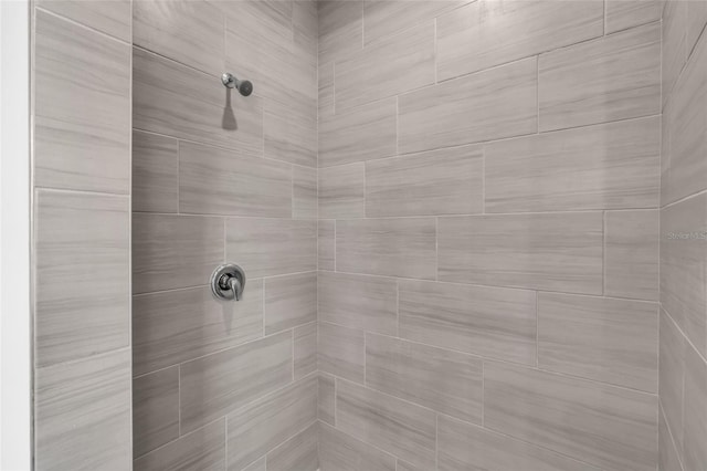 interior details with a tile shower