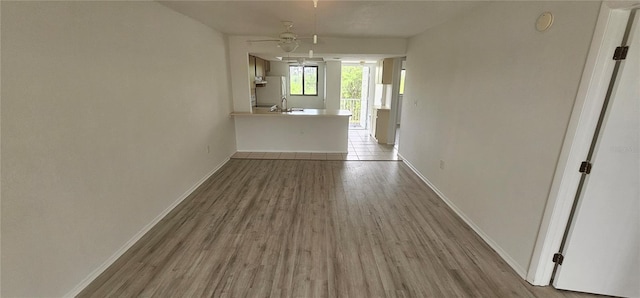 empty room with light wood-type flooring and ceiling fan