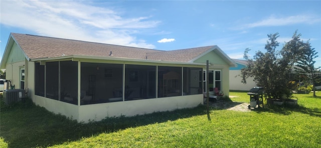 view of side of home with cooling unit, a yard, and a sunroom