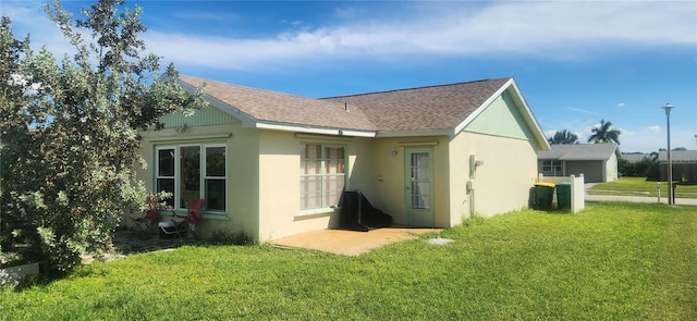 rear view of property with a yard