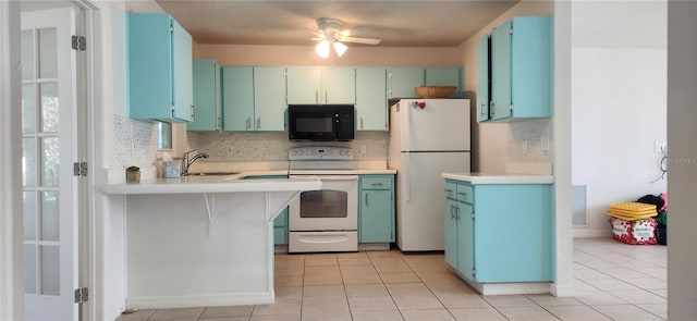 kitchen featuring ceiling fan, white appliances, sink, light tile patterned floors, and a textured ceiling