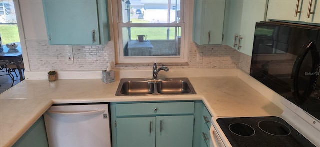 kitchen with dishwasher, decorative backsplash, green cabinets, and sink