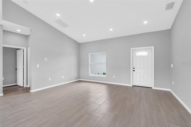 interior space featuring vaulted ceiling and light hardwood / wood-style floors