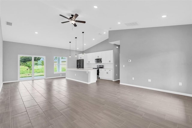 unfurnished living room with ceiling fan, high vaulted ceiling, sink, and light hardwood / wood-style floors