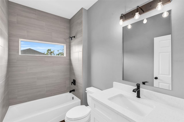 full bathroom featuring toilet, tiled shower / bath, and vanity