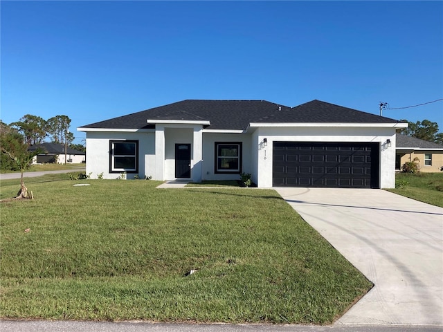 view of front of house featuring a front yard and a garage