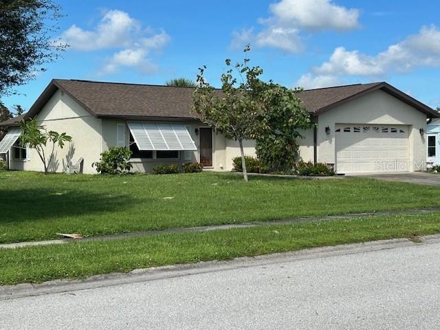 ranch-style home with a front yard and a garage