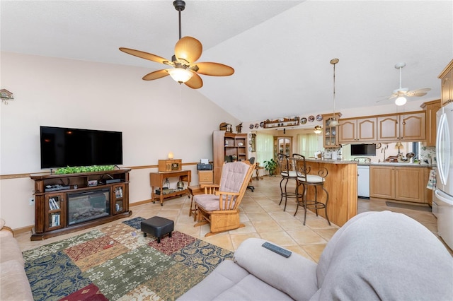 living room featuring ceiling fan, light tile patterned floors, and high vaulted ceiling