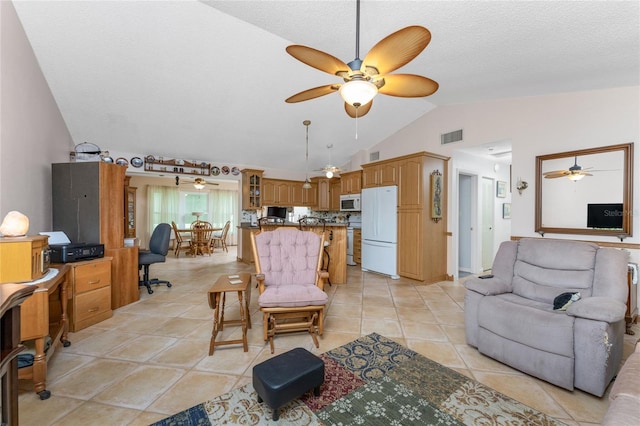 living room with lofted ceiling, ceiling fan, and light tile patterned flooring