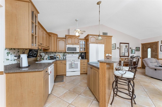 kitchen featuring light tile patterned floors, sink, white appliances, backsplash, and vaulted ceiling