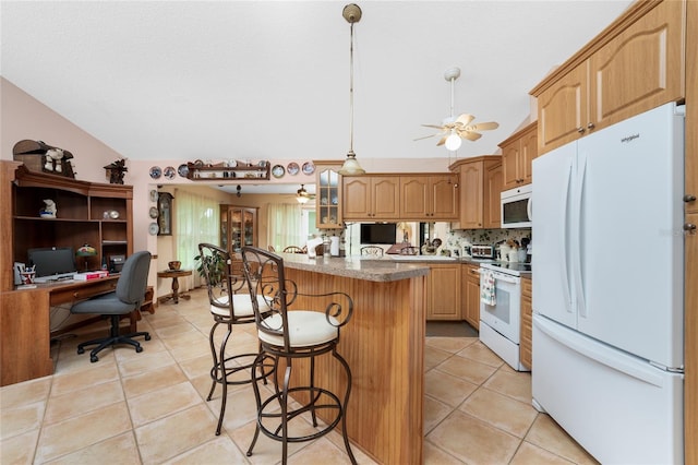 kitchen featuring light tile patterned flooring, tasteful backsplash, a breakfast bar area, a kitchen island, and white appliances