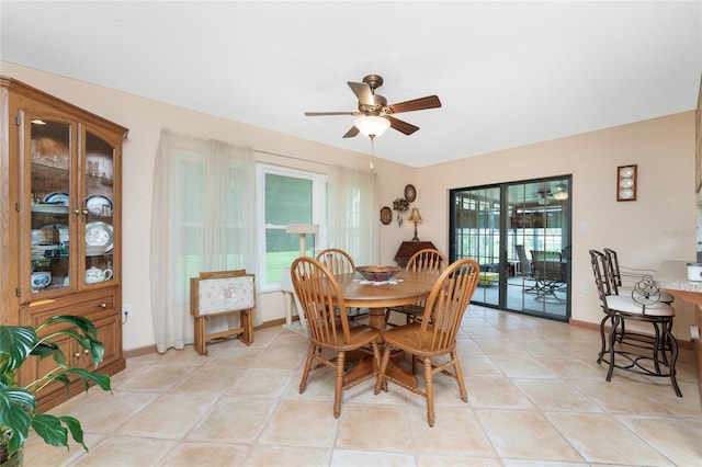 dining area with light tile patterned flooring and ceiling fan