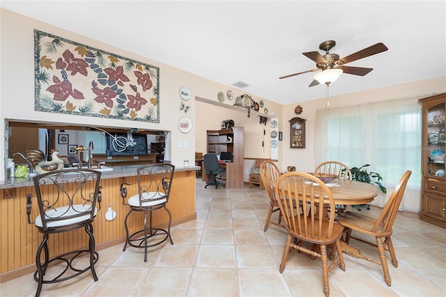 tiled dining room featuring ceiling fan