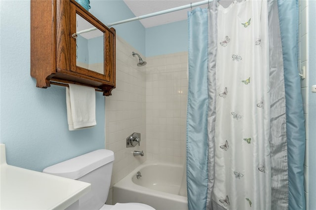 bathroom featuring shower / tub combo and toilet