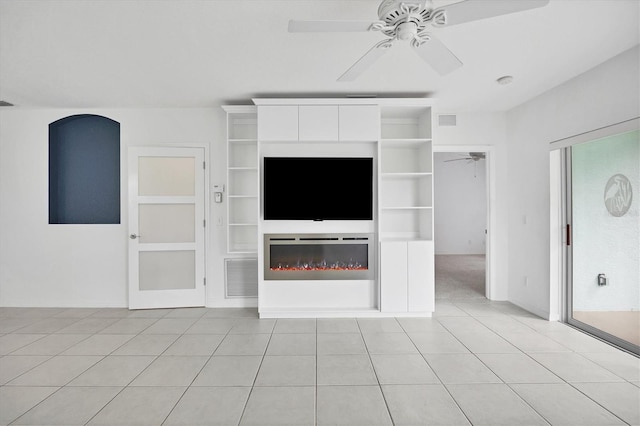 unfurnished living room featuring ceiling fan and light tile patterned floors