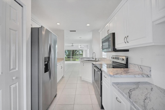 kitchen featuring kitchen peninsula, white cabinetry, sink, and stainless steel appliances