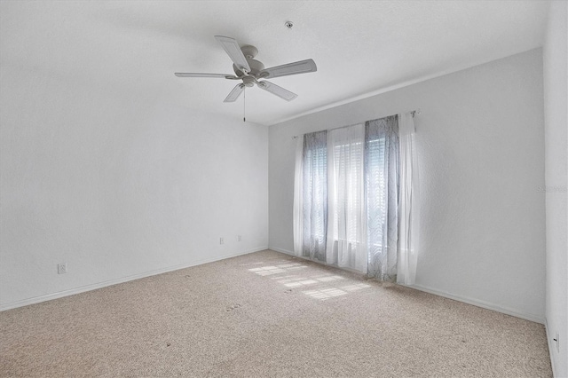 empty room with ceiling fan and carpet