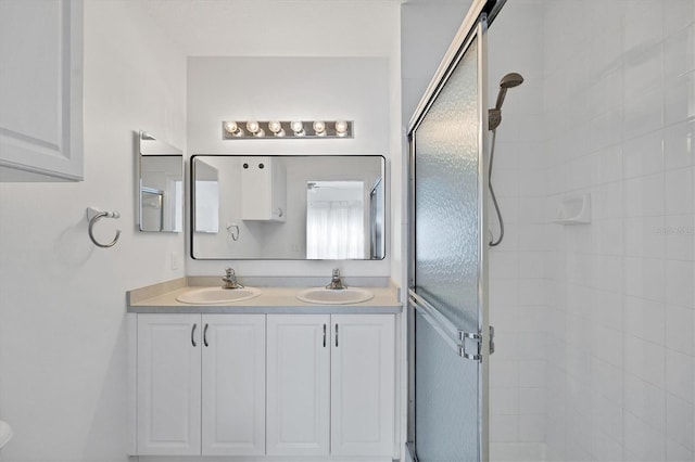 bathroom with walk in shower and vanity