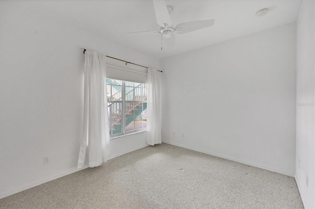 spare room with ceiling fan and light colored carpet